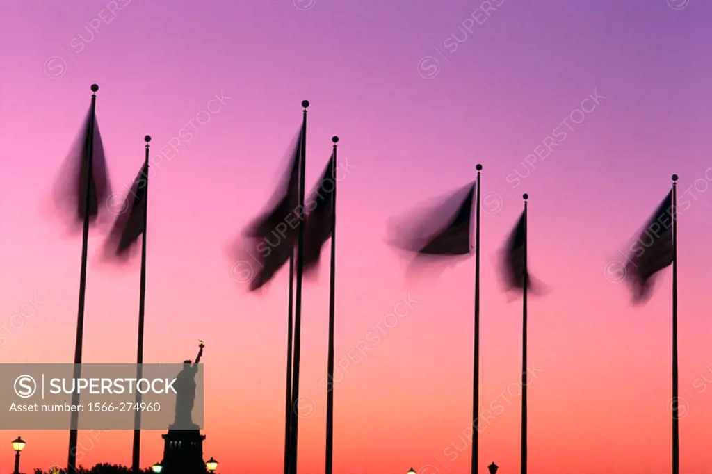 Flags and the Statue of Liberty, USA and a orange magenta sky