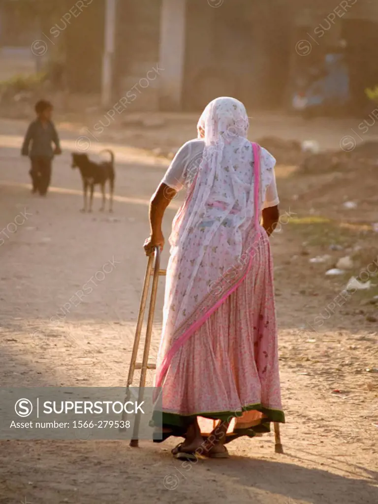 Woman walsk with walker in village of Navrangpura, Gujarat, India