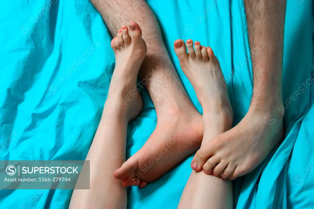 Close-up of teen boy´s and teen girl´s feet playing together