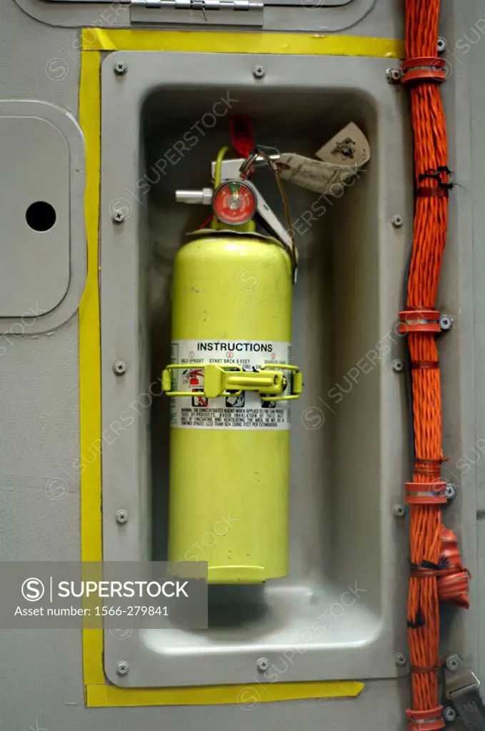 Closeup of fire extinguisher in interior of military cargo aircraft