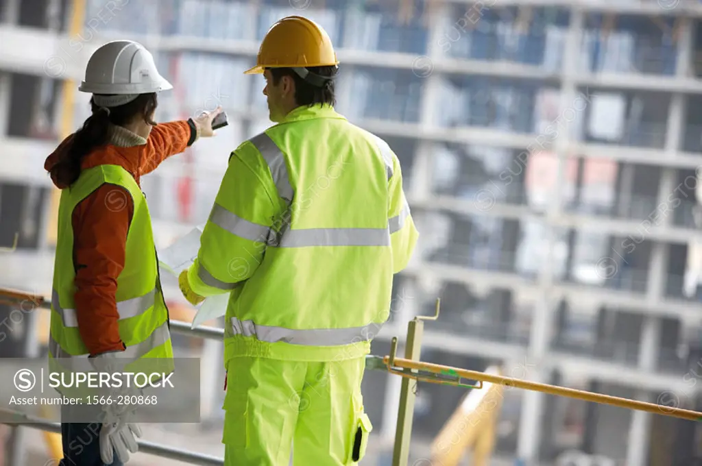 Technicians with reflective clothes and safety equipment. Housing construction, apartments. San Sebastian, Gipuzkoa, Euskadi. Spain.