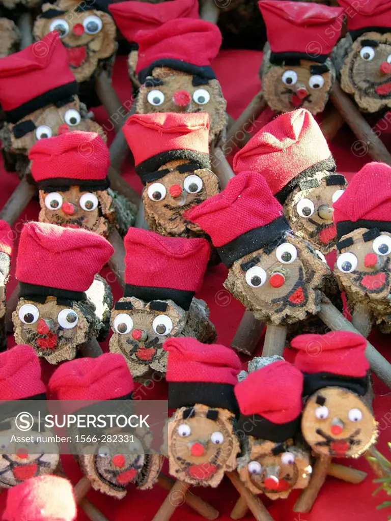 Christmas logs (mythological character relating to a Christmas tradition in Catalonia) for sale at fair. Fira de Santa Llúcia, Barcelona, Catalonia, S...