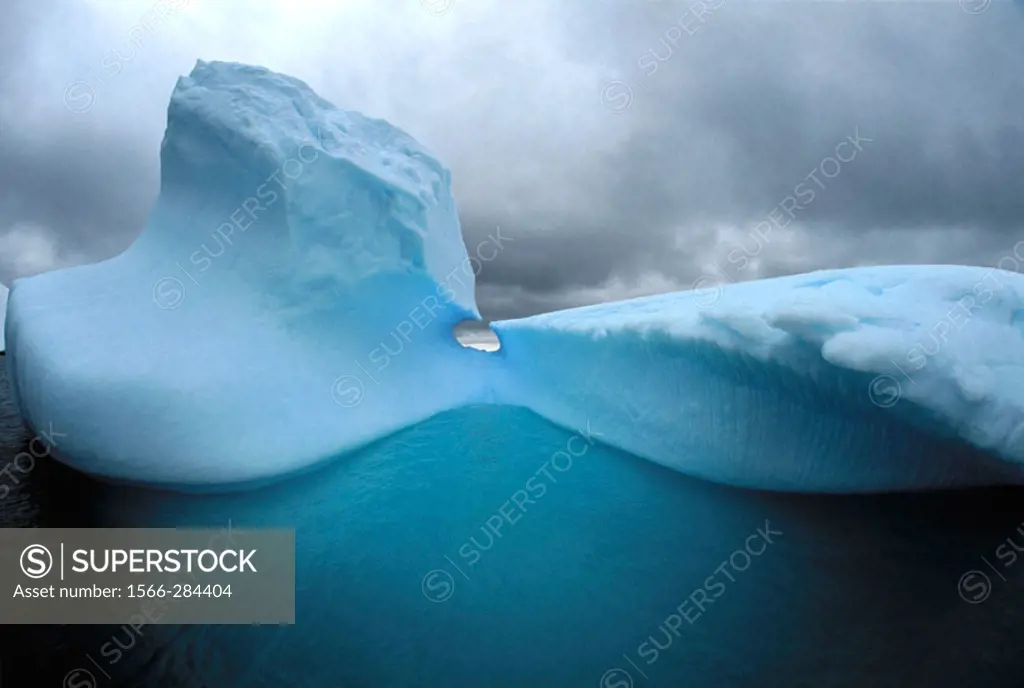 Iceberg and storm clouds. Gerlache Strait. Antarctic Peninsula. Antarctica.