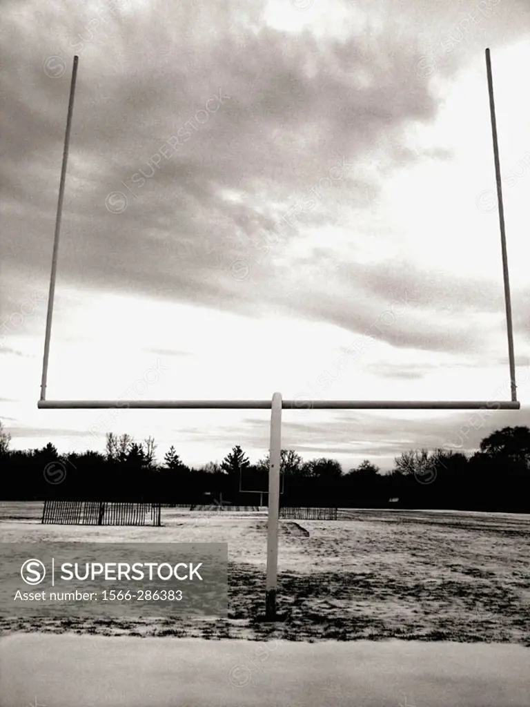 A goalpost at a high school football in Upstate, New York is captured against a dramatic sky.