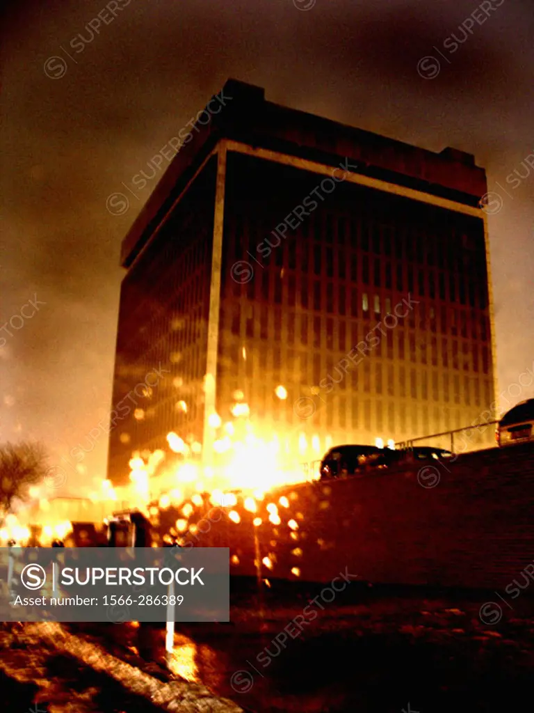 A federal office building is captured at night with a slight blur creating a painterly effect.