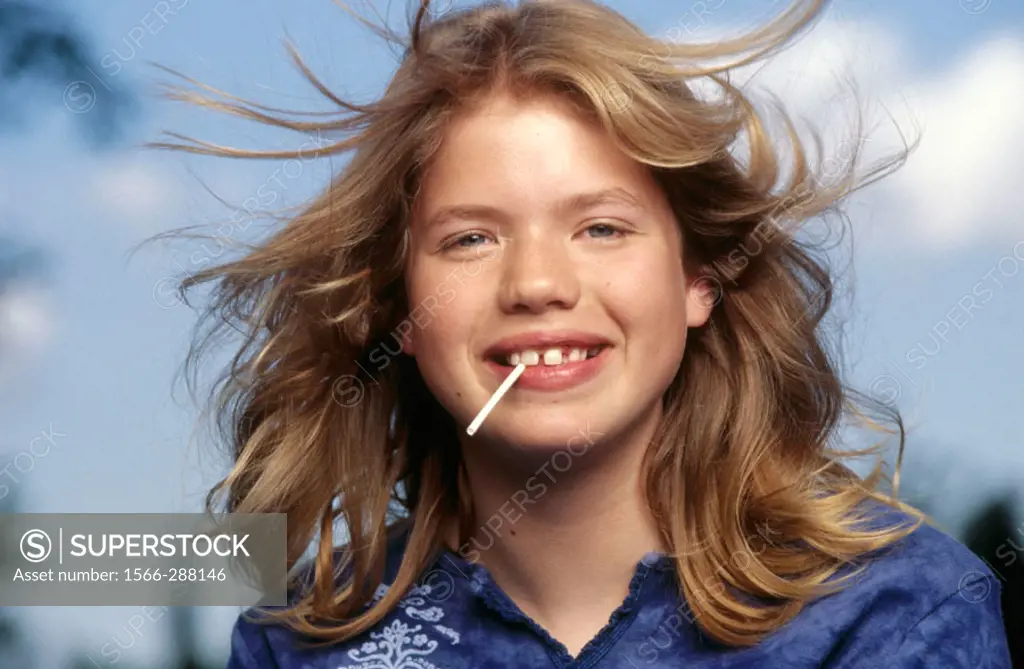 Headshot of Adolescent girl with Lollipop.