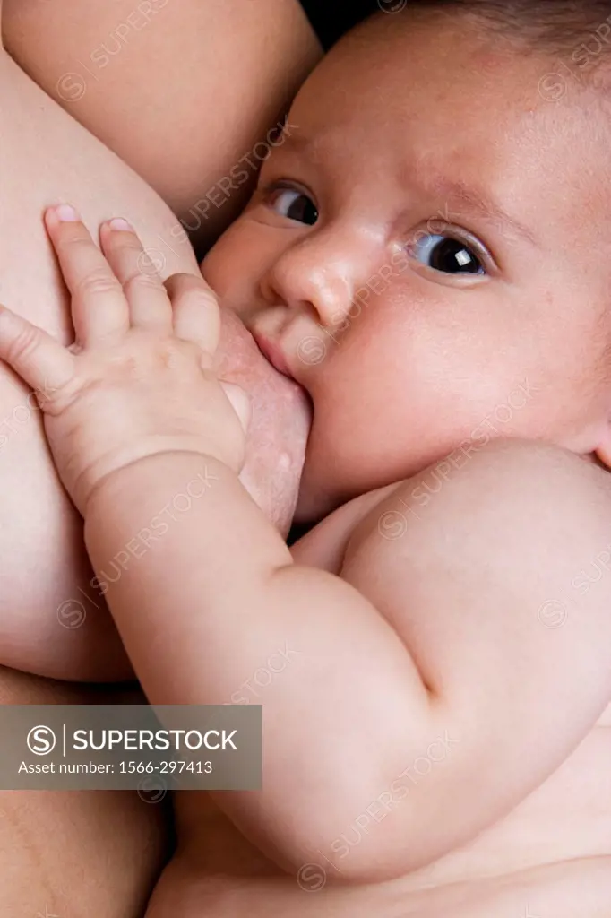 Portrait of baby breastfeeding