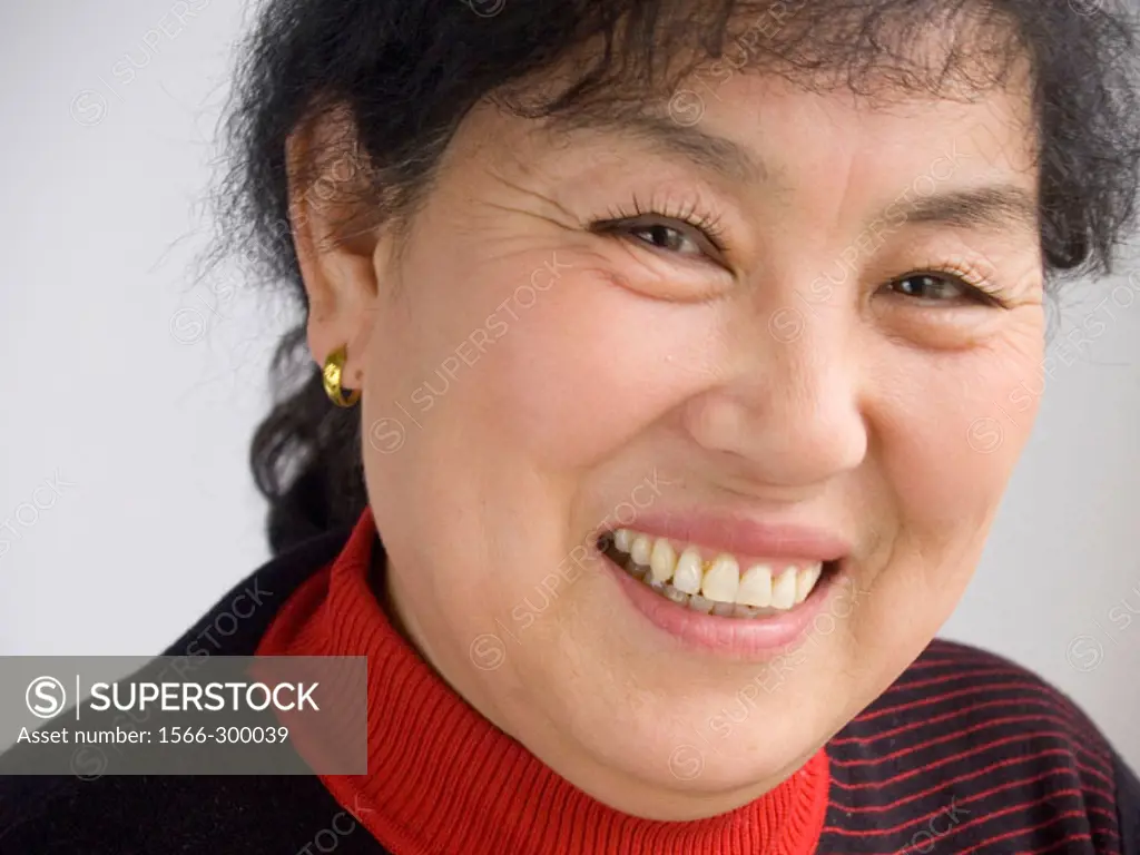 Mature Asian woman smiling to the camera.