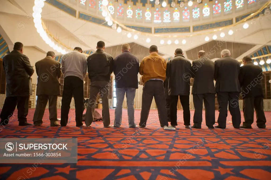 Men at prayer. The King Abdallah mosque also known as Blue Mosque. Amman .Kingdom of Jordan