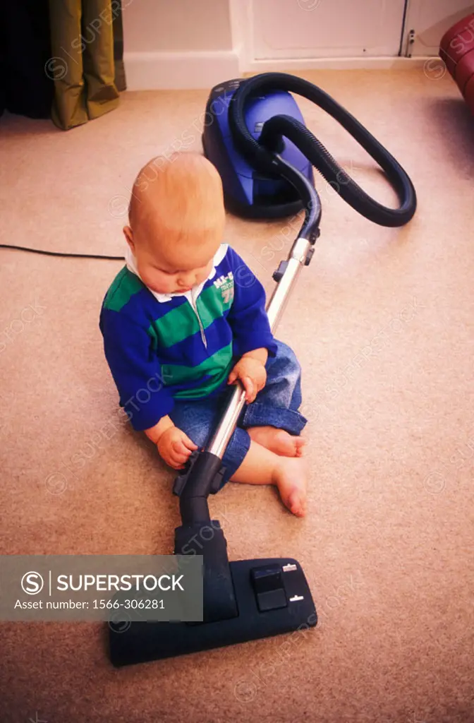 14 month old twin boy playing with hoover