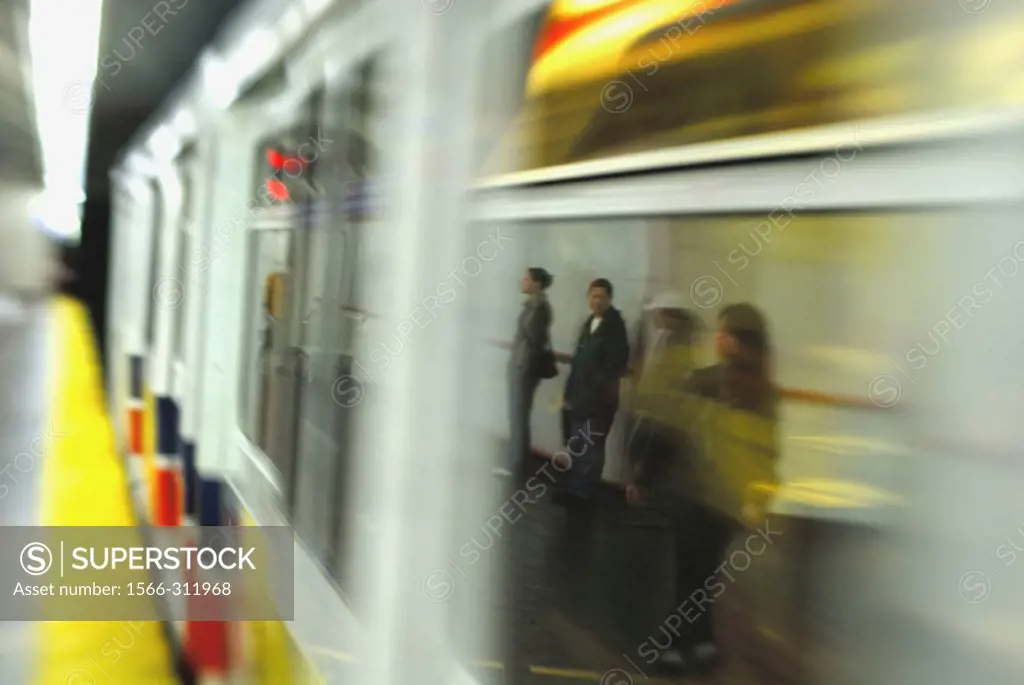 passengers reflected in window of moving skytrain