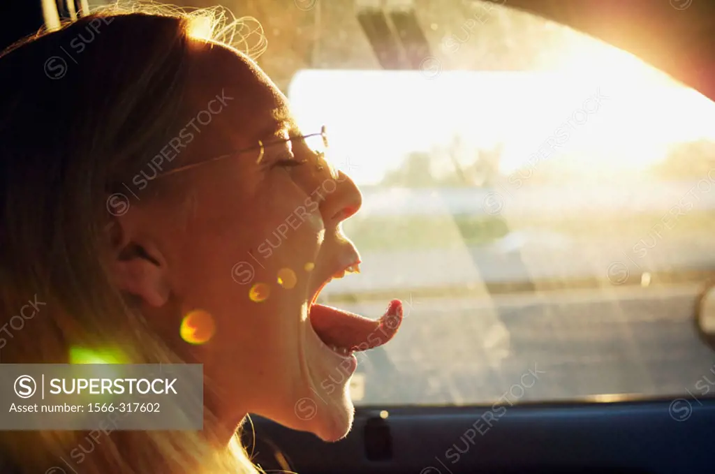 Girl sticking tongue out while driving