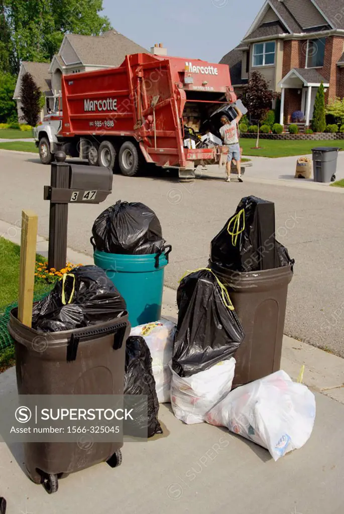 Residential trash collection crew pick up waste products
