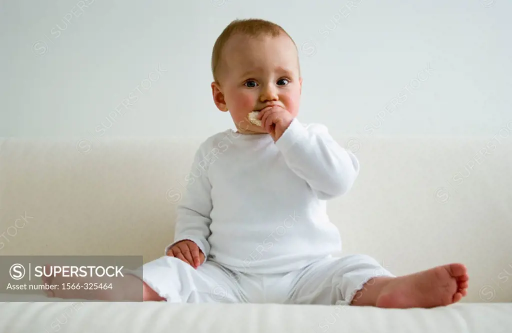Baby eating a rice-cracker