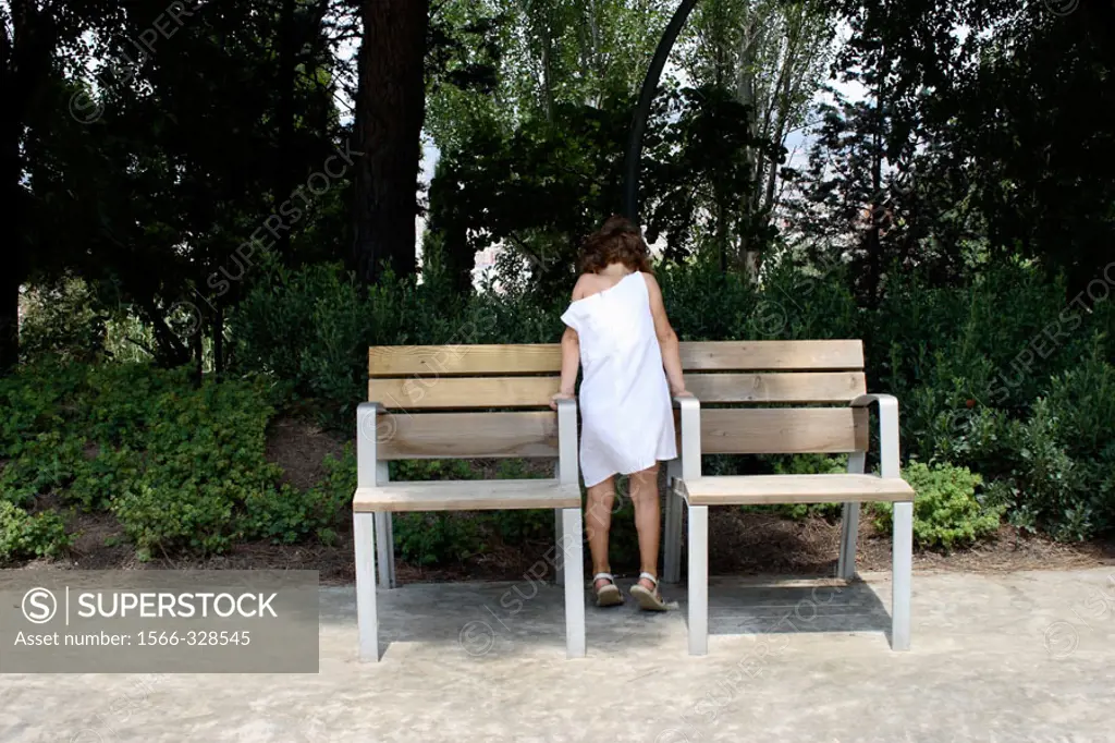 Little girl between two benches.