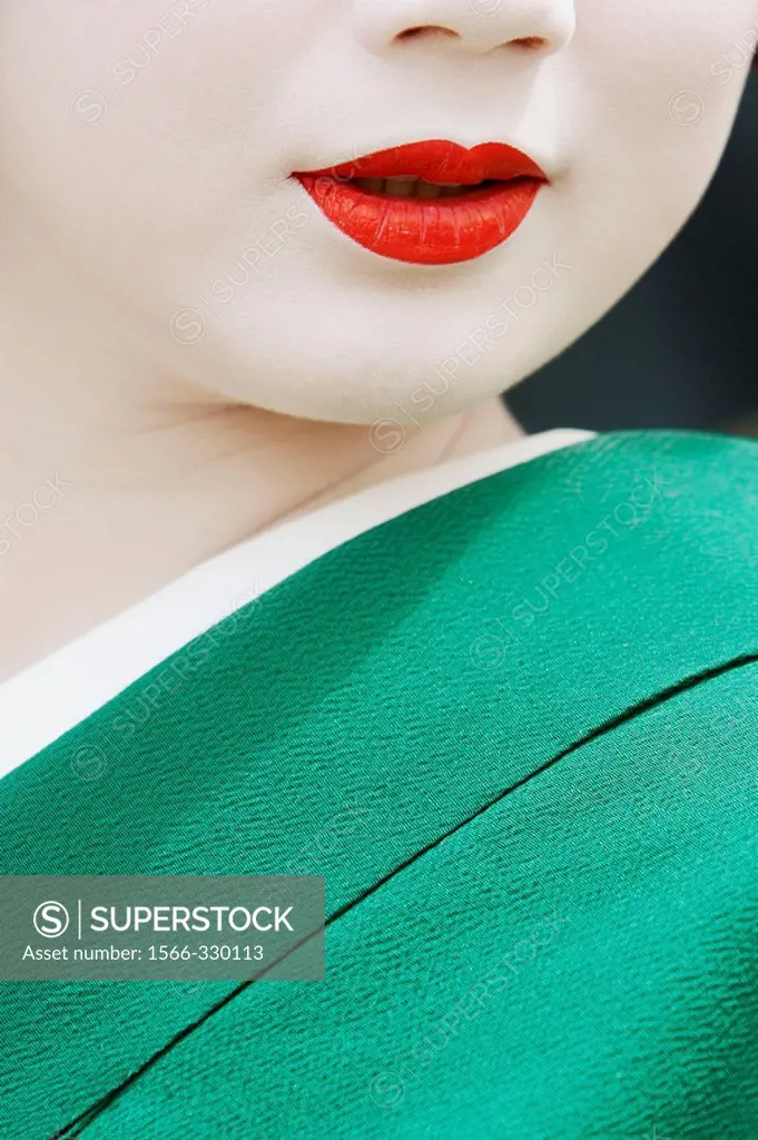 Geisha in traditional make-up and wearing a kimono in the Gion district of Kyoto, Japan.