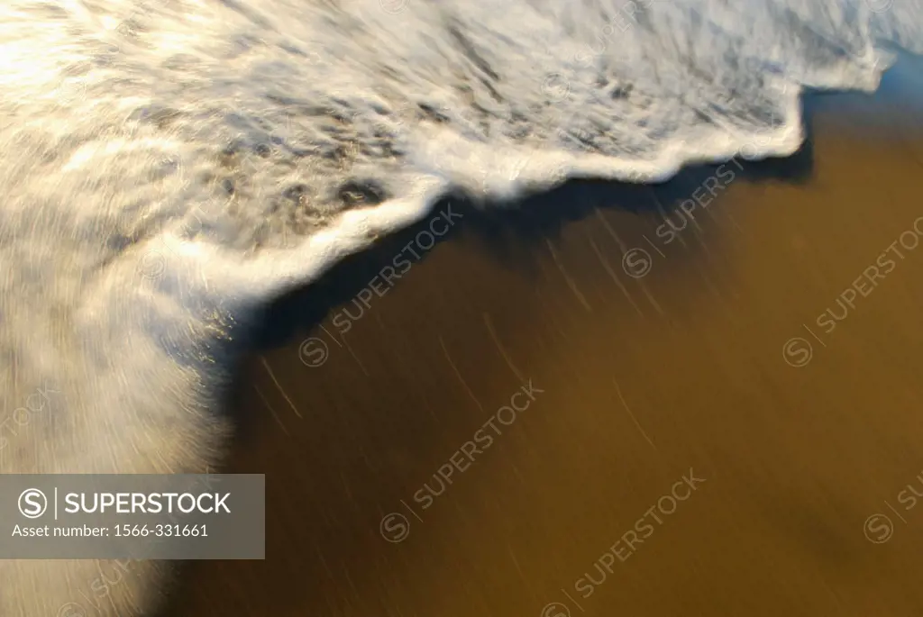 waves rolling onto beach