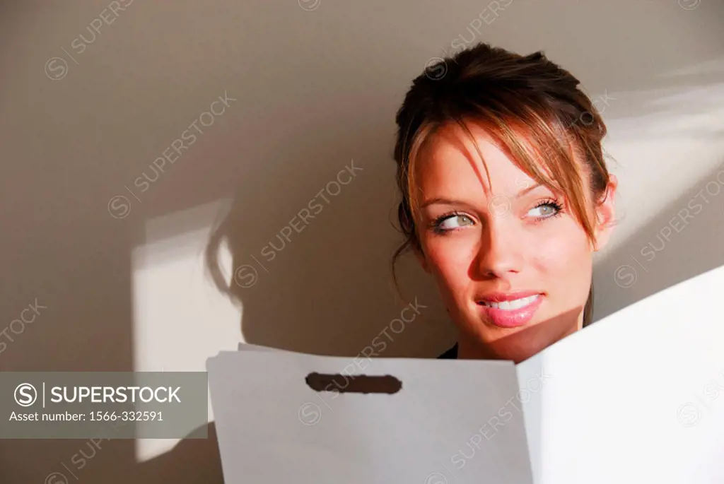20 yr old young woman holding file folder