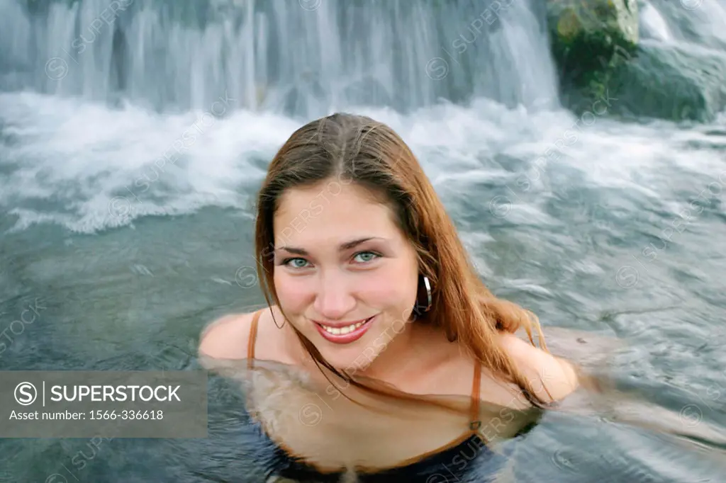 Young Russian woman enjoying hot springs in Yellowstone National Park, Wyoming. USA.