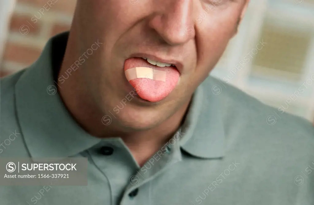 Caucasion man with bandage on tongue; face partially visible. Soft green casual shirt.