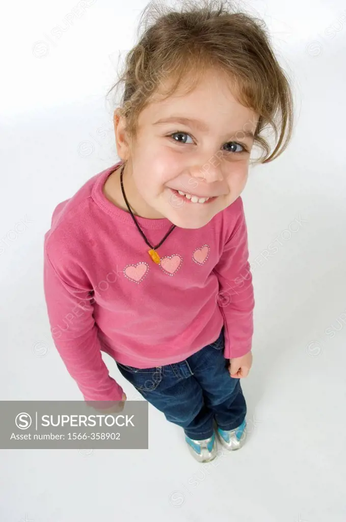 Little girl with happy facial expression top view looks toward the camera
