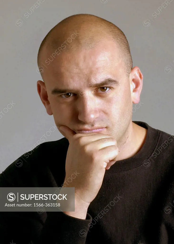 Bald 38 year old man showing a serious expression.