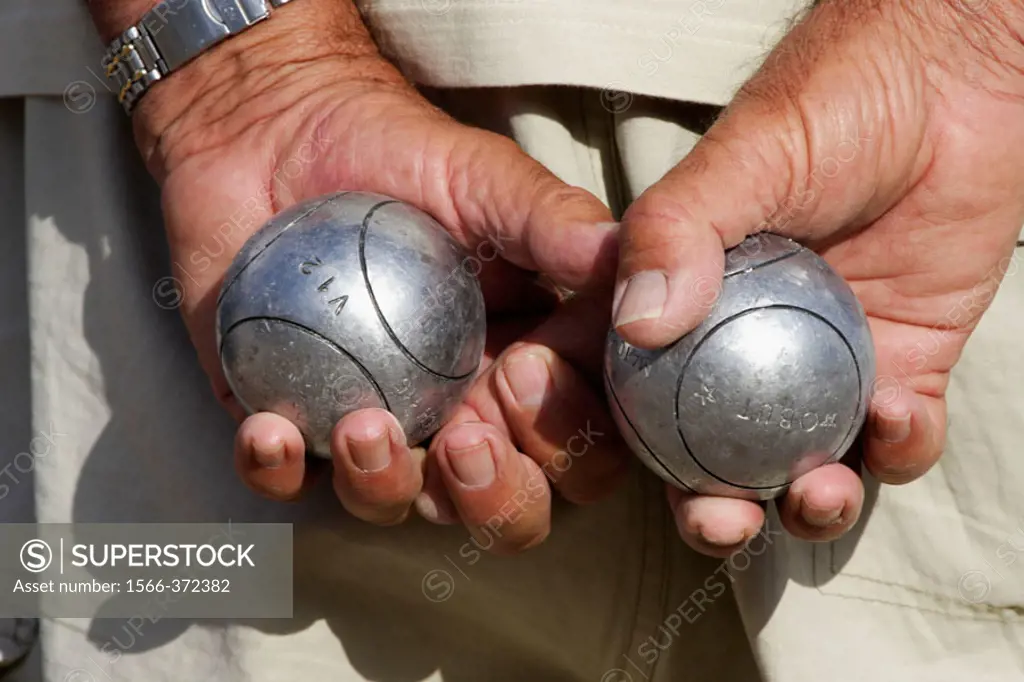 Hands with iron balls, Petanca game. Alicante. Comunidad Valenciana. Spain