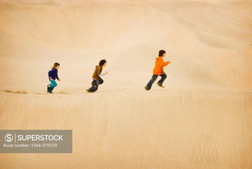 Children run on Sand Dunes, Baja California, Mexico