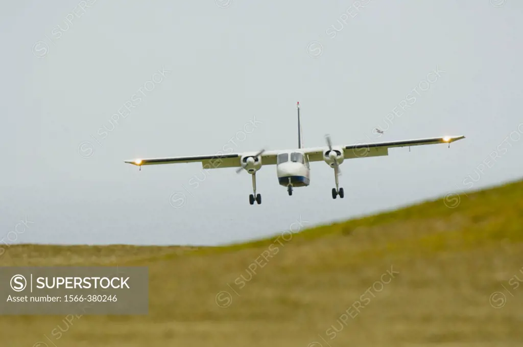 Small aircraft shuttle between Shetland islands landing at Fair Isle landing ground