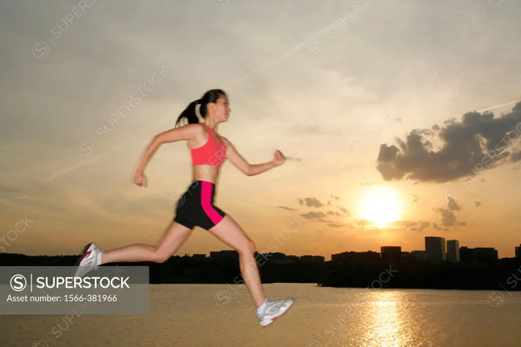 Potomac river, Washington, DC, USA, woman jogging and jumping, 23 years old, Asian.