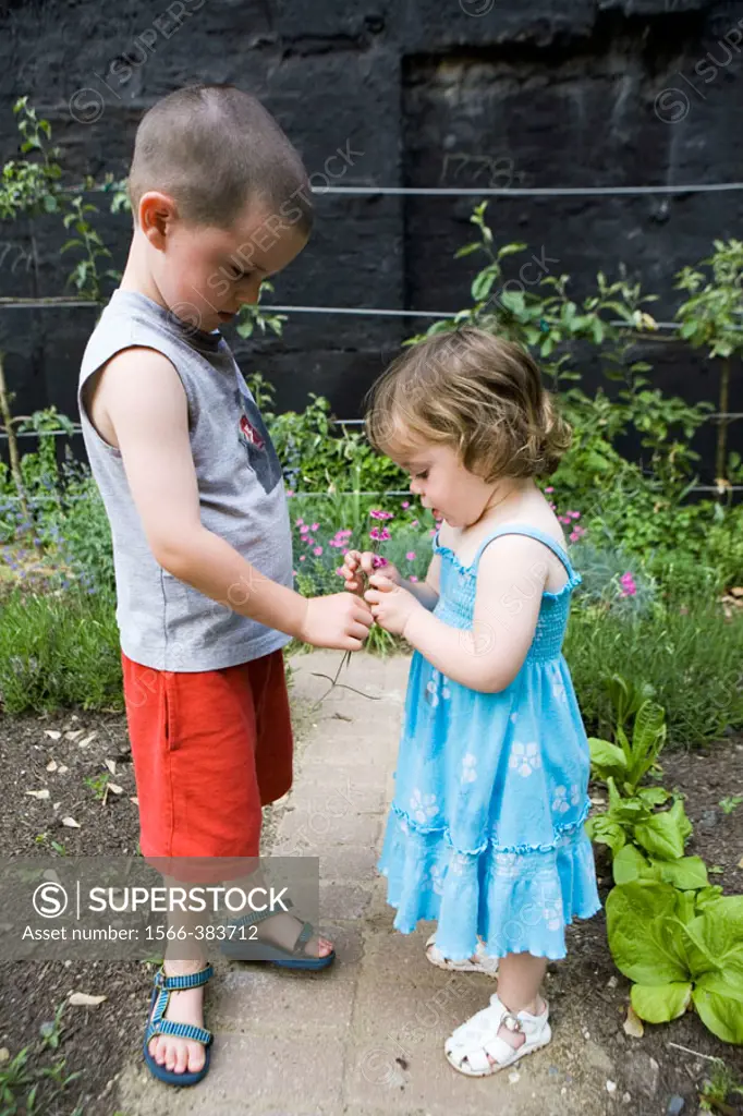 Brother and sister in garden.