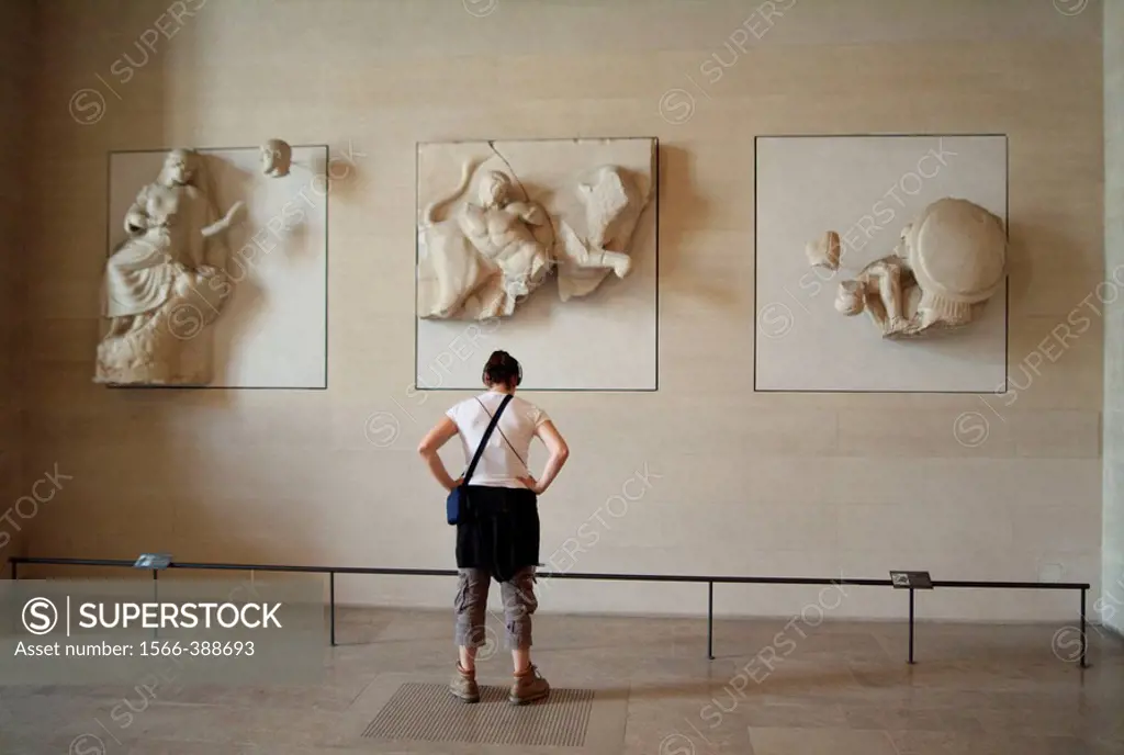 Visitor with headphones guide, in Hall of Roman reliefs. Louvre Museum. Paris. France