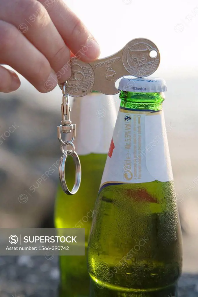 Opening beer bottle using coin-shaped key ring device