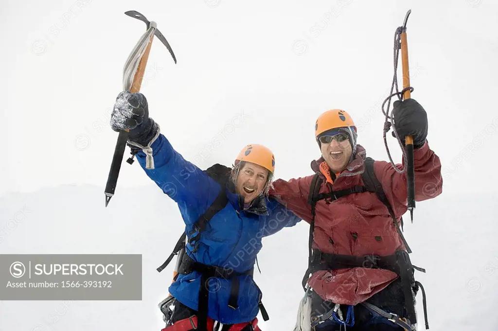 Enthusiastic mountaineers in Snowy Mountain with ice axes