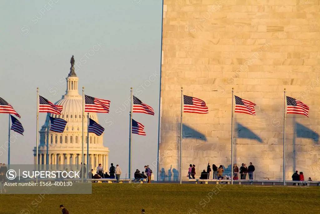 United States, Washington, District of Columbia, US Capitol Building with flags at the Washington Monument and tourists.