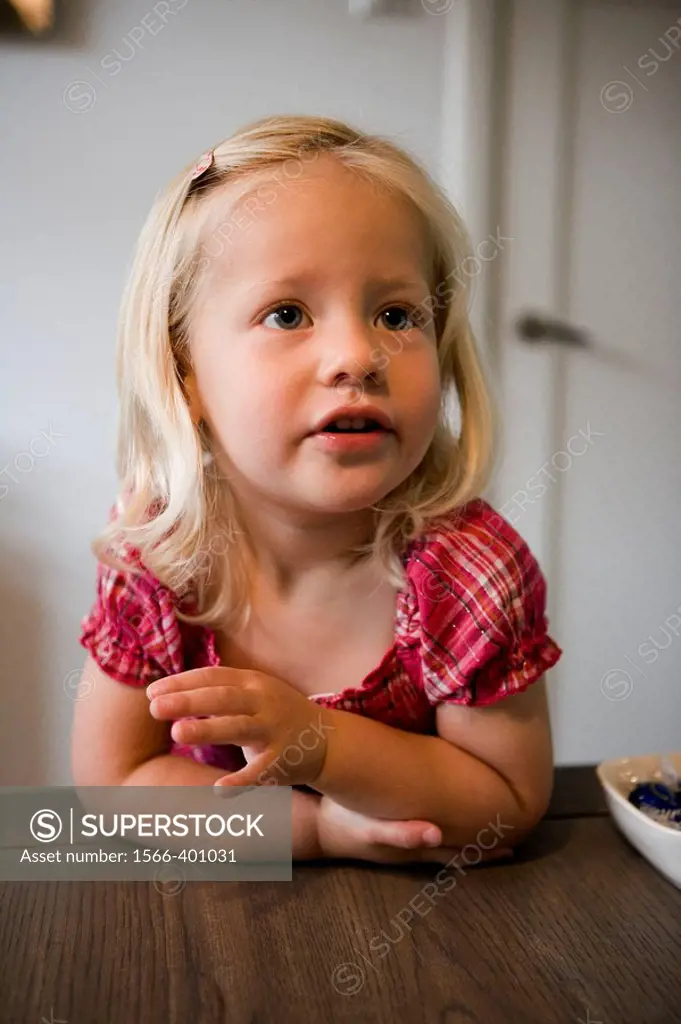 Little girl behind a table