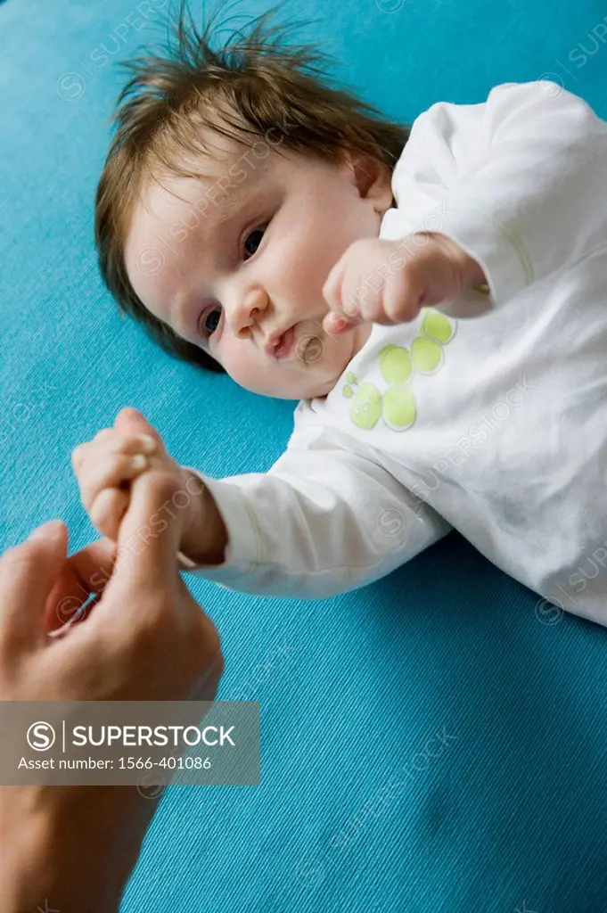 Baby holding his mothers finger