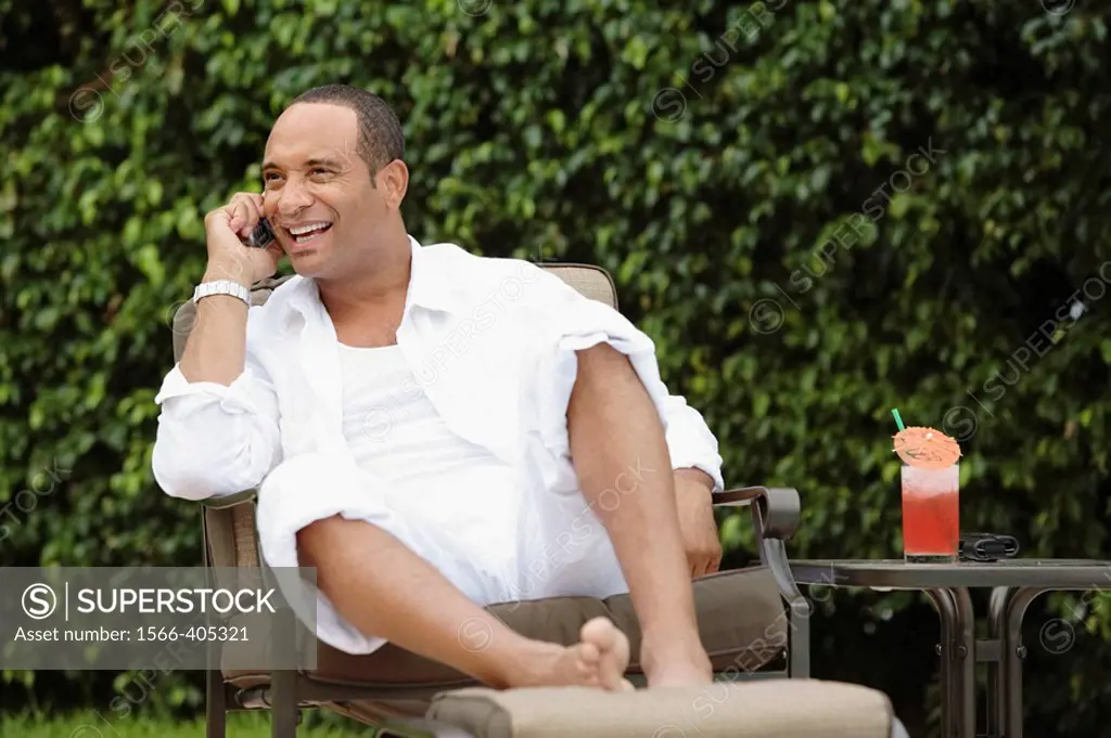 Man poolside on cell phone