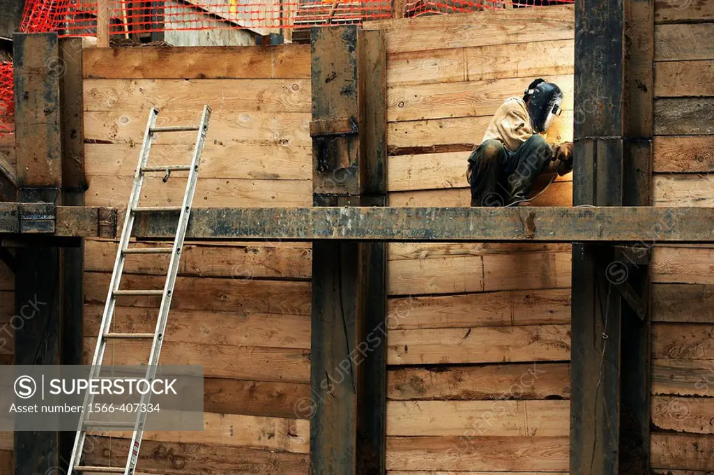 Construction welder, welding a steel beam