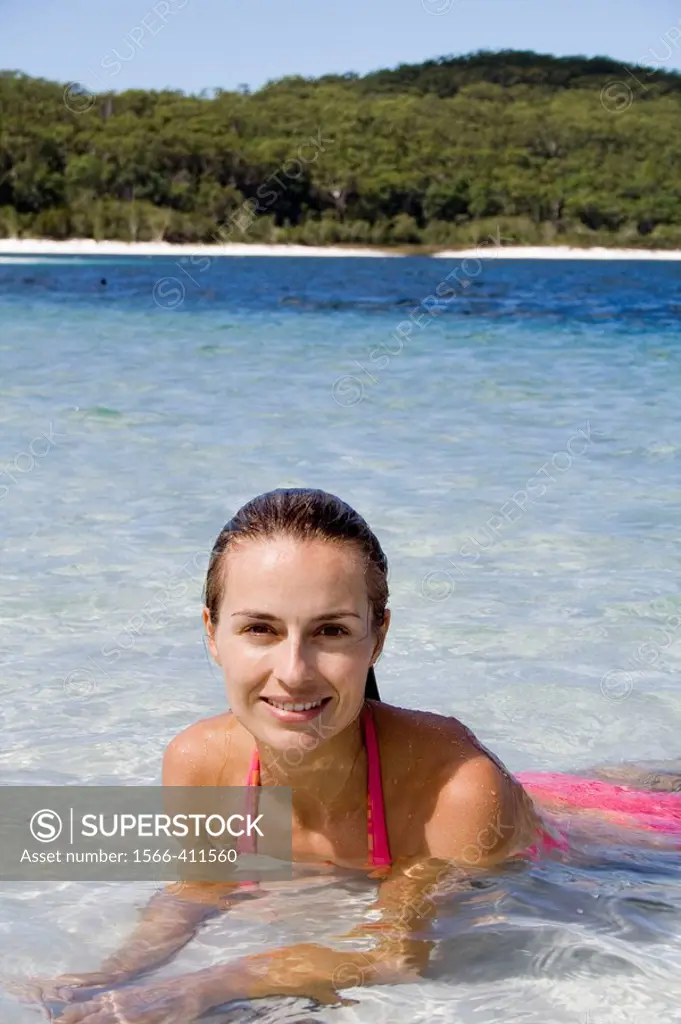 Beautiful woman lying in shallow water. Fraser Island, Australia