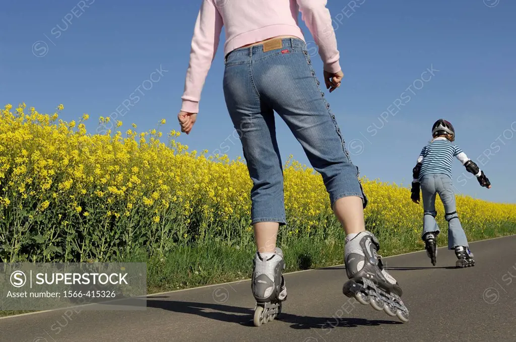 Mother and daughter on roller skates, Inline skates, Saxony, Germany.
