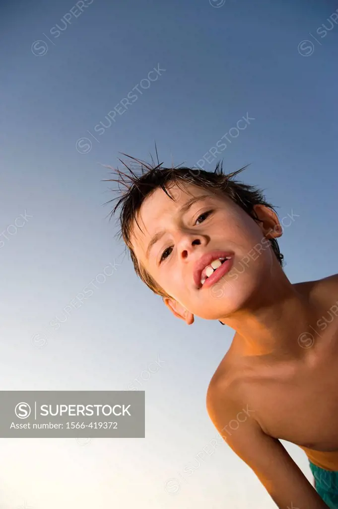 Boy in bathing suit looking at camera at the beach, Hollywood, Florida, USA