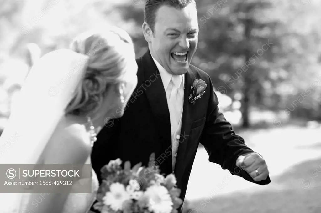 elated groom stealing away with his bride after the wedding ceremony