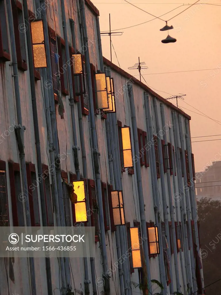 Sunset light is reflected on glass finished window shutters of a residential building at Vadgaon Budruk  Pune, Maharashtra, India