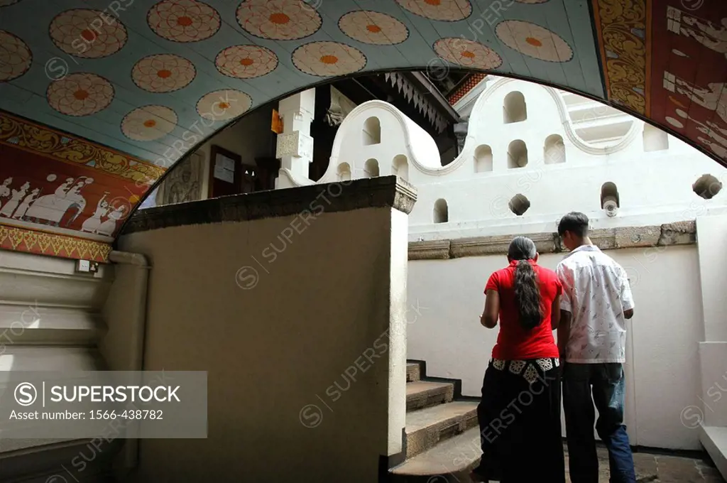 Kandy Sri Lanka: a young couple entering the Temple of the Tooth