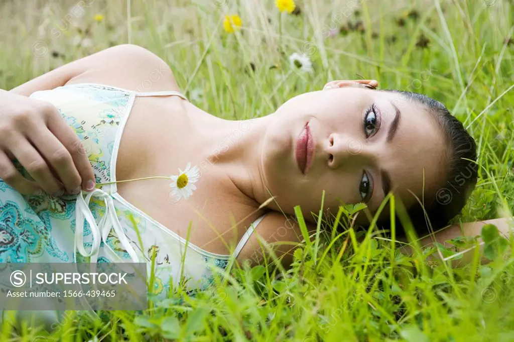 Young woman lying in field of wildflowers