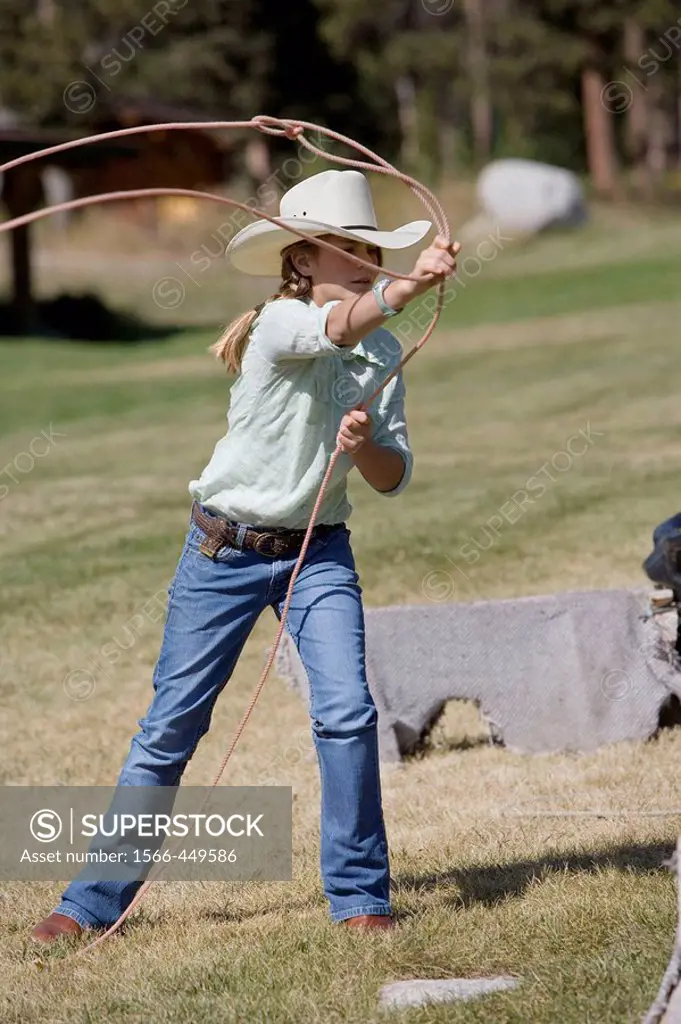Girl throwing a lasso, Lone Mt Ranch, Big Sky, Montana, USA
