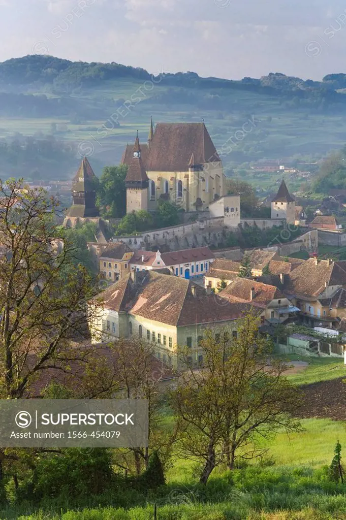 Biertan village with fortified church in morning mist