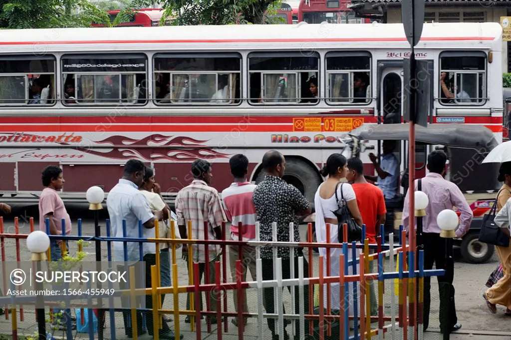 People waiting for a bus in downtown Colombo, Sri Lanka, South Asia