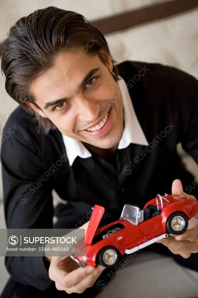 Man holding a collecting miniature car